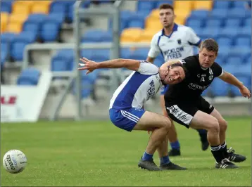  ??  ?? Newtown’s Dean Odlum tries an unorthodox method of getting the better of St Pat’s full-back Shane Murley during the SFC clash in Joule Park Aughrim.