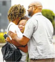  ?? PHOTO BY MARK WEBER/DAILY MEMPHIAN VIA AP ?? People embrace outside a Walmart store following a shooting Tuesday in Southaven, Miss.