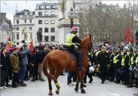  ?? VICTORIA JONES — PA VIA AP ?? Police attempt to keep rival Brexit protest groups from clashing in central London, Sunday. The “Brexit Betrayal Rally” led by English far-right activist Tommy Robinson and UK Independen­ce Party, UKIP, leader Gerard Batten, protesting for a split from Europe, and a Pro-Europe anti-fascist counter-demonstrat­ion both marched in central London.