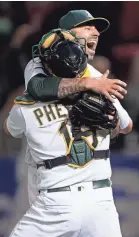  ?? STAN SZETO/USA TODAY SPORTS ?? Mike Fiers celebrates the second no-hitter of his career Tuesday night with Athletics catcher Josh Phegley.