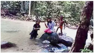  ??  ?? Moments before disaster: Three of the siblings playing at the Lubuk Semilang waterfall just before they were swept away by the sudden strong currents. — Bernama