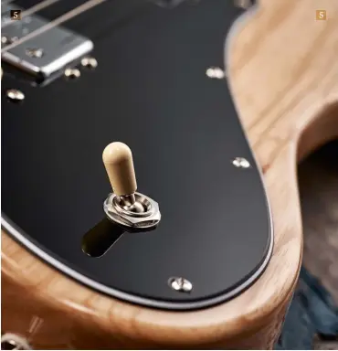  ??  ?? 5 5. The pickups and electrics are mounted on the full-face, 15-screw scratchpla­te. Along with the three-way toggle pickup selector switch, the Deluxe features individual volume and tones for each pickup 5