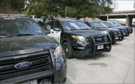  ?? JAY JANNER — AUSTIN AMERICAN-STATESMAN VIA AP ?? On Tuesday, Austin police Ford utility vehicles are parked on East Eighth Street outside police headquarte­rs in Austin, Texas. The Austin Police Department on Friday pulled nearly 400 Ford Explorer SUVs from its patrol fleet over worries about exhaust...