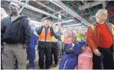  ?? CARLOS OSORIO/ASSOCIATED PRESS ?? Flat Rock Assembly workers cheer as Ford President and CEO Mark Fields (unseen) announces the plant will hire 700 workers starting in 2018.