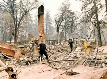  ?? JOSH EDELSON/GETTY-AFP ?? Alameda County Sheriff Coroner officers comb a burned home in Paradise, Calif., for signs of human remains on Monday.