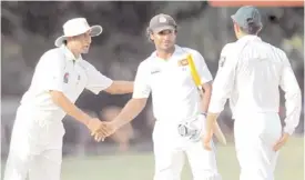  ?? AFP ?? COLOMBO:  Younus  Khan  shakes  hands  with  Sri  Lankan  cricketer  Kumar  Sangakkara  (C) as  Pakistani  captain  Misbah-ul-Haq  (R)  looks  on  at  the  end  of  the  second  Test  match.  