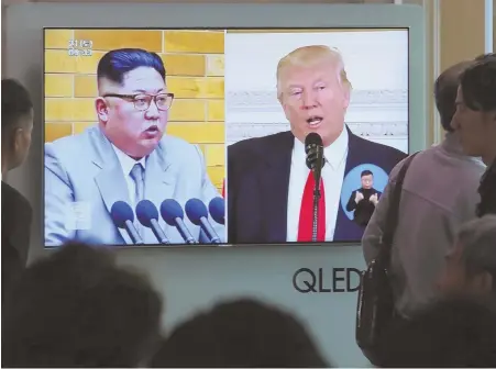  ?? AP PHOTO ?? DEJA VU: People watch a TV screen showing file footage of U.S. President Trump, right, and North Korean leader Kim Jong Un at the Seoul Railway Station in Seoul, South Korea, yesterday.