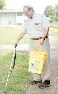  ?? Keith Bryant/The Weekly Vista ?? Master Naturalist Jerry Butler picks up garbage during his weekly cleanup at Tanyard Creek. He goes out every Tuesday morning, he said, and tries to leave the park looking its best.