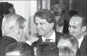  ?? The New York Times/AL DRAGO ?? President Donald Trump congratula­tes Donald McGahn during his swearing in as White House counsel Jan. 22, 2017, at the White House. McGahn disagreed with Trump’s order to fire special counsel Robert Mueller in June and threatened to quit.