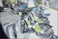  ?? K.M. Cannon Las Vegas Review-journal @Kmcannonph­oto ?? E-bikes for rent share a bicycle rack Monday at the Regional Transporta­tion Commission. The electric pedalassis­t bikes are the RTC fleet’s rentable bikes.