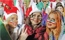  ?? — AFP ?? Iranian women watch the Group B match between Portugal and Iran at Azadi Stadium in Tehran on Monday night.