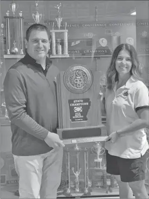  ?? Special to The Saline Courier ?? Benton bowling Coach Brandy Chumley, right, and Benton Athletic Director Scott Neathery hold up the 5A Boys Bowling State Championsh­ip trophy. Chumley was named the AHSAA Coach of the Year, her second, recently after leading the Panthers to the state title earlier this year.