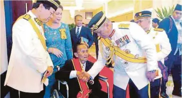  ??  ?? PANGLIMA Medan Timur Tentera Darat, Lt Jeneral Datuk Stephen Mundaw bersalaman dengan Awang (tengah) selepas selesai upacara istiadat pengurniaa­n, semalam.