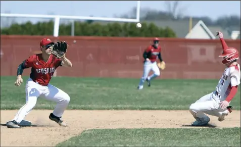  ?? Photo by John Zwez ?? Kaden Siefring of Wapakoneta lines up to take a throw as a runner from St. Henry begins to slide during Saturday’s game at WHS. See more photos at wapakdaily­news.com.