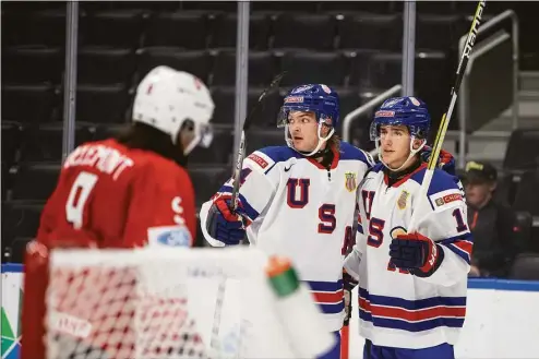  ?? JASON FRANSON / Associated Press ?? United States' Mackie Samoskevic­h, right, and Carter Mazur celebrate a goal against Switzerlan­d during the second period of an IIHF world junior hockey championsh­ips game Thursday, Aug. 11, 2022, in Edmonton, Alberta. (Jason Franson/The Canadian Press via AP)