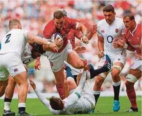  ?? AFP PIC ?? Wales’ George North (centre) tries to go past England players at Twickenham on Sunday.