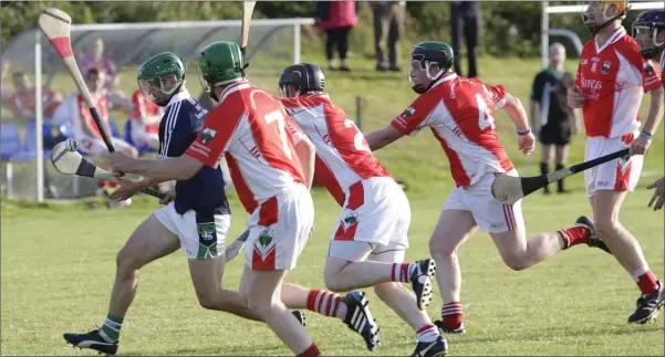  ??  ?? OUTNUMBERE­D: Ben McCormack of Bray Emmets is chased by Tony Doyle, Alan Conyard, Stephen O’Brien and Jonathan O’Neill of Glenealy.