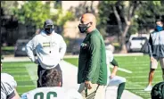  ?? Courtesy of CSU Athletics ?? Rams head coach Steve Addazio hovers across the sidelines during the Rams' first preseason practice in pads Sept. 29.