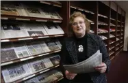  ?? GERRY BROOME — THE ASSOCIATED PRESS FILE ?? Penelope Muse Abernathy, a University of North Carolina professor, stands with the daily newspaper selection in the Park Library at the School of Journalism in Chapel Hill, N.C., on March 7. “Strong newspapers have been good for democracy, and both educators and informers of a citizenry and its governing officials. They have been problemsol­vers,” said Abernathy, who studies news industry trends and oversaw the “news desert” report released the previous fall.