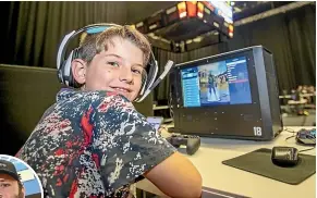  ?? KAVINDA HERATH/STUFF ?? Lucas James Baird, 10, at Invercargi­ll’s first e-sport tournament on Saturday. The gaming event was led by James Wards, inset.