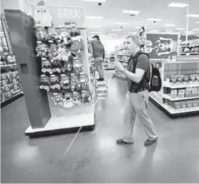  ?? DAVID JOLES/STAR TRIBUNE ?? Steve Decker, blind since birth, uses the Aira app on his phone to navigate the downtown Minneapoli­s Target store.