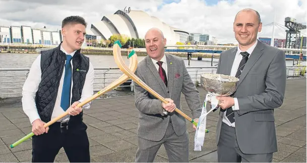  ??  ?? QUICK ON THE DRAW: Stuart Walken and Mark Whitehouse, of tournament sponsor cottages.com, cross camans, while the Camanachd Associatio­n’s Derek Keir holds the silverware at yesterday’s MacTavish Cup draw at Pacific Quay, Glasgow