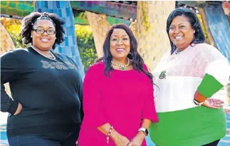  ?? [CHRIS LANDSBERGE­R PHOTOS/ THE OKLAHOMAN] ?? Wearing their Alpha Kappa Alpha sorority pink and green sorority apparel at Myriad Botanical Gardens, Tianna Carter, Karen Carter and Christina Kirk have said they are proud of their sorority sister, Vice President-elect Kamala Harris.