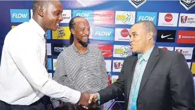  ?? CONTRIBUTE­D PHOTOS ?? Carlo Redwood (right), VP of marketing at FLOW, greets STATHS Technical Director Michael Williams, and captain Jaedin White during the ISSA/FLOW Super Cup Tournament draw held at the ATL Audi Showroom on Oxford Road in New Kingston on Thursday night.