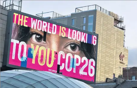  ?? REUTERS ?? THE WORLD IS WATCHING: An advertisin­g board is seen during the UN Climate Change Conference, in Glasgow, Scotland, Britain, on Sunday.