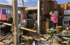  ?? AP-Jay Reeves ?? Patti Herring sobs as she sorts through the remains of her home in Fultondale, Ala., on Tuesday after it was destroyed by a tornado.