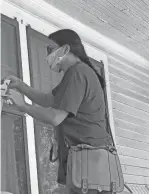  ?? RASHIDA FOR CONGRESS ?? U.S. Rep. Rashida Tlaib leaves materials for a voter at a house in Detroit. At a time when coronaviru­s is a major concern, campaign traditions like knocking on doors have come under scrutiny.