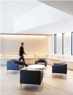  ??  ?? RIGHT: Honed limestone floors and Baltic birch built-ins with concealed lighting add an ethereal air to the lobby.