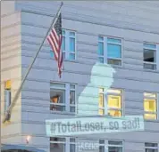  ?? AP ?? Greenpeace projected a banner showing US President Donald Trump with a slogan '#TotalLoser, so sad!' on the facade of the US Embassy in Berlin on Friday