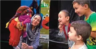  ??  ?? Afghan children meet Sesame street Muppet 'Zari' after a recording at a television studio in Kabul.