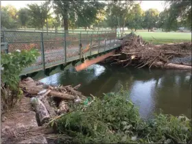  ?? EVAN BRANDT — MEDIANEWS GROUP ?? Debris washed down the Manatawny Creek during Thursday’s flooding made the damage to the pedestrian bridge here even worse.