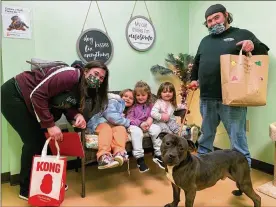  ?? CONTRIBUTE­D ?? A family poses with the dog they adopted fromtheGre­ene County Animal Care and Control shelter. The shelter entered a contest to seewhich shelter could adopt out the most pets during the holiday season.