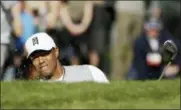  ?? GREGORY BULL — THE ASSOCIATED PRESS ?? Tiger Woods hits out of a bunker on the 10th hole at Torrey Pines Golf Course during the third round of the Farmers Insurance Open.