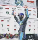  ?? Matt Slocum / Associated Press ?? Kevin Harvick celebrates in the winner’s circle after winning the NASCAR Cup Series auto race at Pocono Raceway on Saturday.