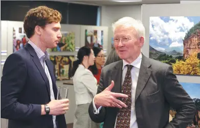  ?? WANG BO / CHINA DAILY ?? Discussion­s about Tibetan culture are the order of the day at the Color of West China exhibition in London on Thursday. Roger Croston (right), a council member of the Royal Society for Asian Affairs, exchanges views with another participan­t. Croston...