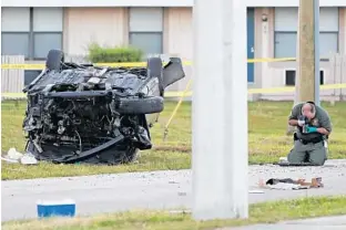  ?? AMY BETH BENNETT/SOUTH FLORIDA SUN SENTINEL PHOTOS ?? A Broward Sheriff's Office crime scene technician photograph­s a weapon found in the street next to a crashed Nissan Altima in Pembroke Park on Friday, Oct. 26, 2018.