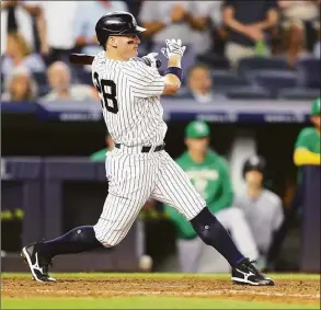  ?? Mike Stobe / Getty Images ?? The Yankees’ Josh Donaldson hits a two-run double in the seventh inning against the Athletics on Monday.