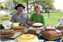  ?? PHOTO: DOUG FIELD/STUFF ?? Checking out the cakes baked by blokes at the Fairlie Heritage Market on Saturday are Graeme Lane and Sonya Callaghan.