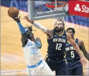  ?? GERALD HERBERT — THE ASSOCIATED PRESS ?? Montrezl Harrell (15), who led the Lakers with 18 points, goes to the basket against Pelicans center Steven Adams.