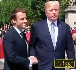  ??  ?? A good start: Mr Macron and Mr Trump warmly shake hands