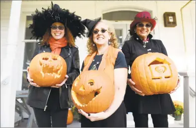  ?? Tyler Sizemore / Hearst Connecticu­t Media ?? Executive Director Gaby Rattner, center, holds a pumpkin at the Halloween Pumpkin Carving Contest judging at Community Centers, Inc. of Greenwich in 2018. Rattner admitted that she isn’t sure what to expect in the coming years as Connecticu­t residents prepare for life after COVID-19.