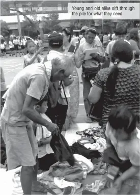  ??  ?? Young and old alike sift through the pile for what they need.