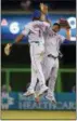  ?? WILFREDO LEE — THE ASSOCIATED PRESS ?? Amed Rosario, left, and Juan Lagares celebrate after the Mets defeated the Marlins.