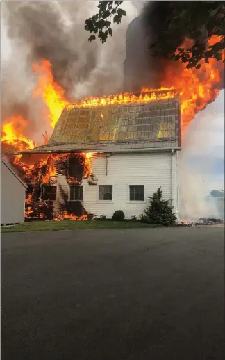  ?? MARK WALSH — MEDIANEWS GROUP ?? Flames break through the roof of this barn in Honey Brook Township.