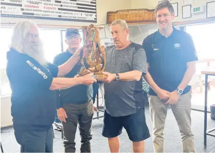  ?? ?? Club of the Year award being presented to the Kāwhia Boating & Angling Club (from left): club Commodore Charlie Smart, Cecil Hickman and Doug Taucher (Kāwhia delegates to NZSFC), and NZSFC chief executive Mike Plant.