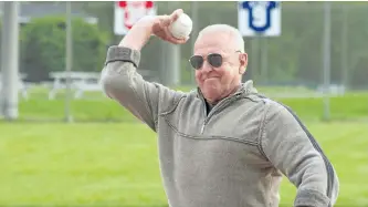  ?? JASON BAIN/EXAMINER ?? Peterborou­gh and District Sports Hall of Fame inductee Dan Sharpe throws out the ceremonial first pitch on opening night of the Peterborou­gh Men's Softball Associatio­n city league season at the George (Red) Sullivan East City Bowl on Tuesday night. See...